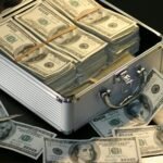 grey metal case of hundred dollar bills